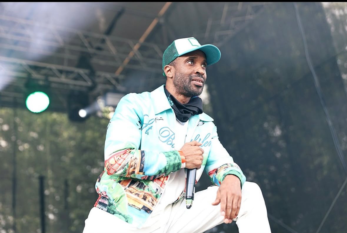 Raver performing live on stage with a microphone at a South London festival